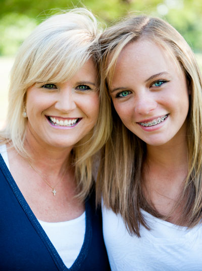 girl smiling with her mom after getting braces